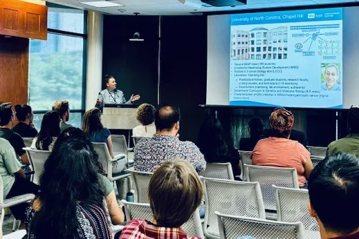 Dr. Tiki Hayes presenting at the Channing Der Career Symposium in front of a crowd. 