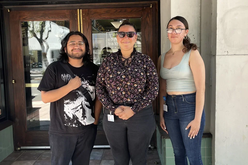 Diego, Tiki, Kimberely in front of a sandwich shop.