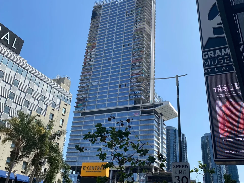 Highrise building covered in wall art in downtown LA. 