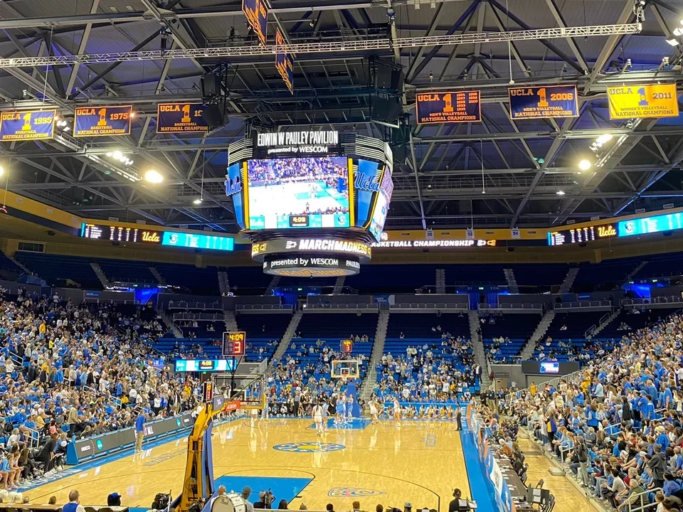 UCLA Basketball gym with crowd, court, and jumper in view. 